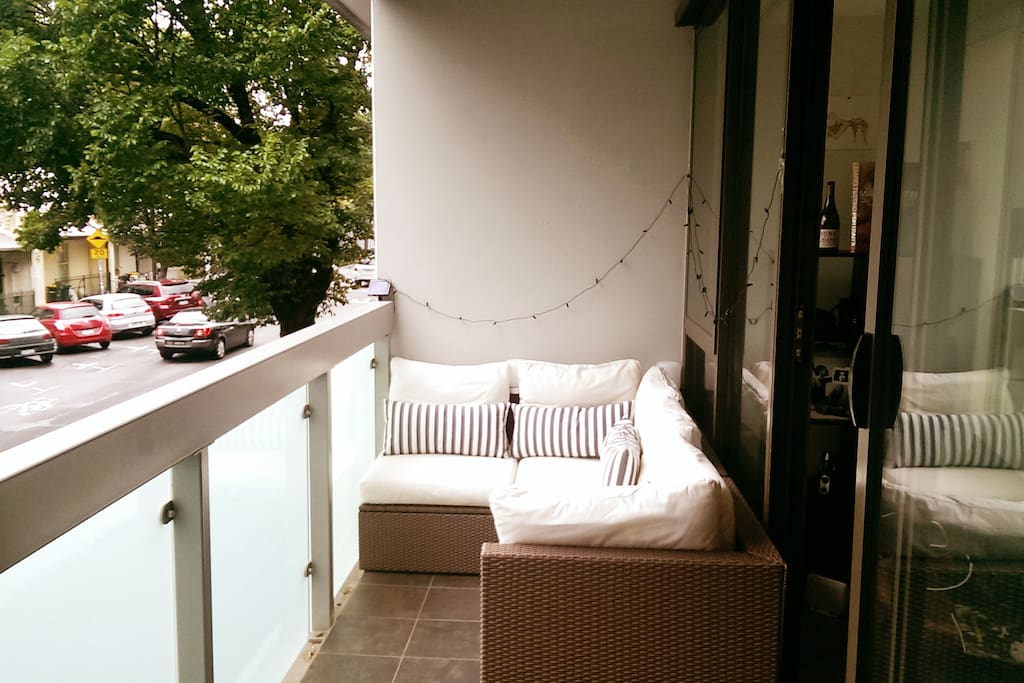 Comfy Ikea outdoor setting on large balcony overlooking beautiful leafy streets of Fitzroy. Ambient lights come on at night, very relaxing.