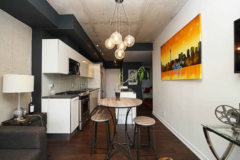 View of kitchen from the living room. Bar table with stools for casual dining