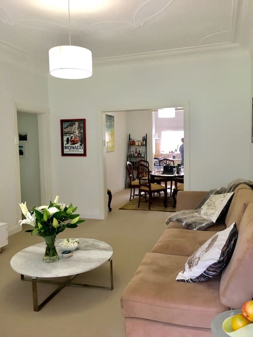 Lounge room, looking into large dining room and modern kitchen / laundry