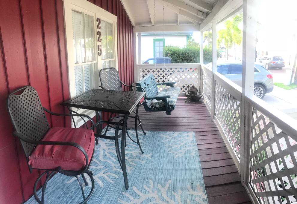 Front porch with table chairs and swing