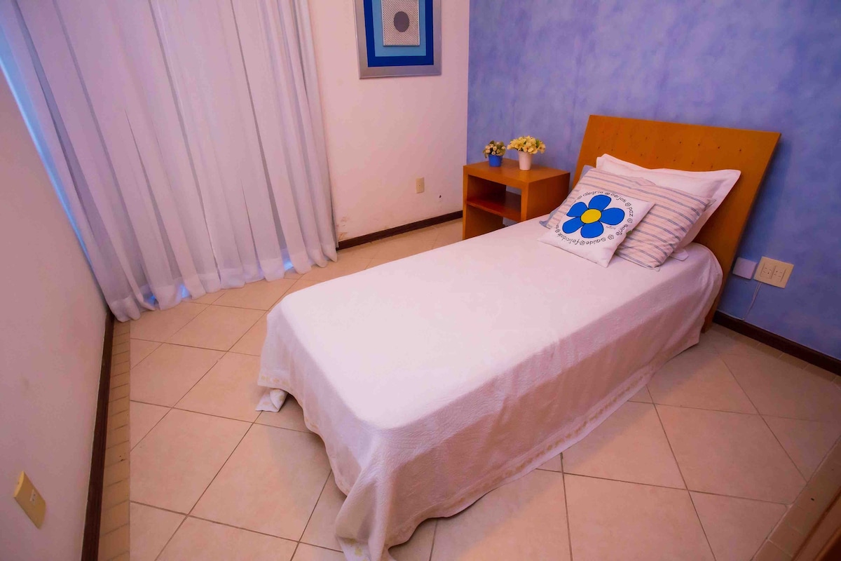 房间配有两张单人床、分体式空调、吊扇、阳台通道、遮光窗帘和衣柜衣柜。