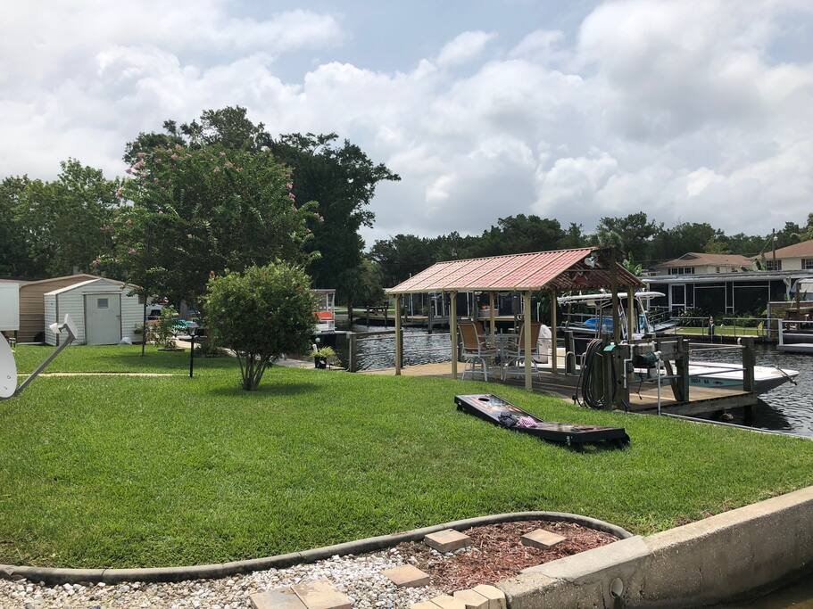 Covered boat dock with overhead fan and lights, right on the canal