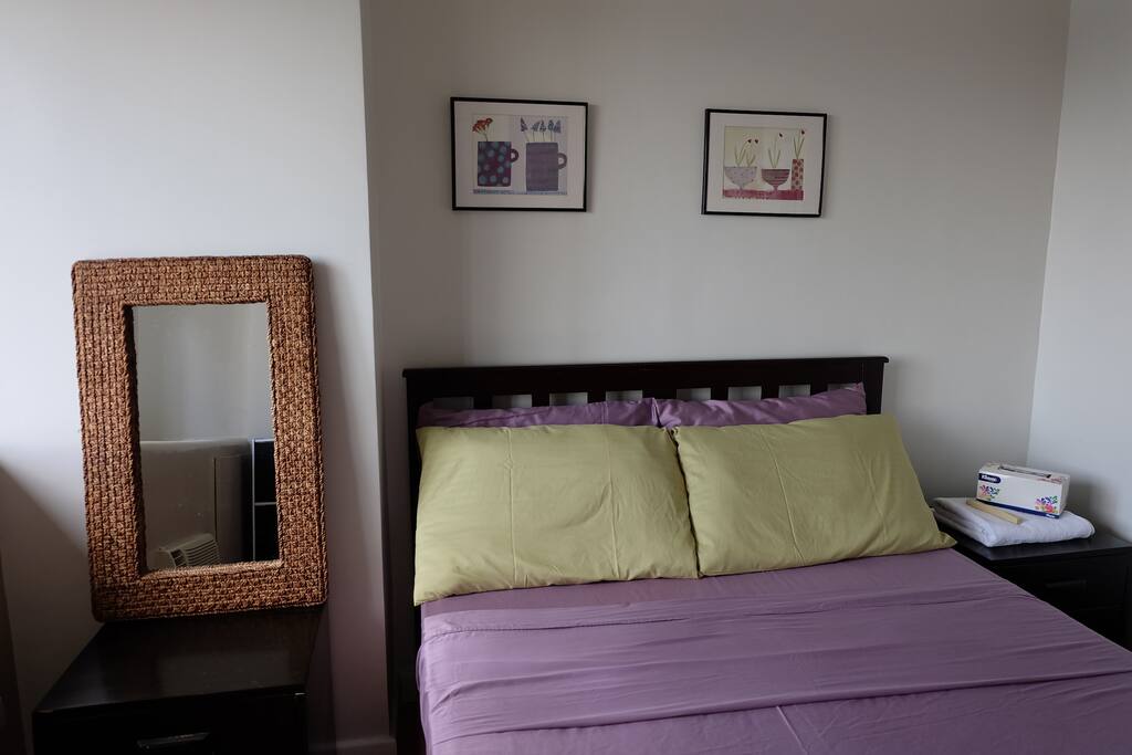 Bedroom has queen-sized bed and its own window-type aircon