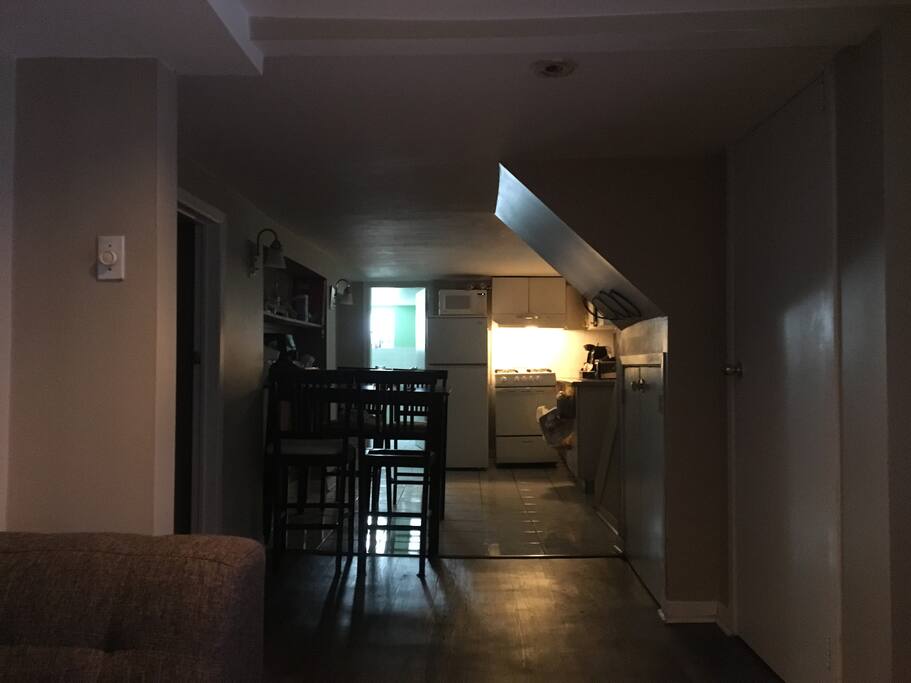 Living space Featuring Dining Room table, and two storage spaces, including one with cleaning supplies and a dehumidifier.