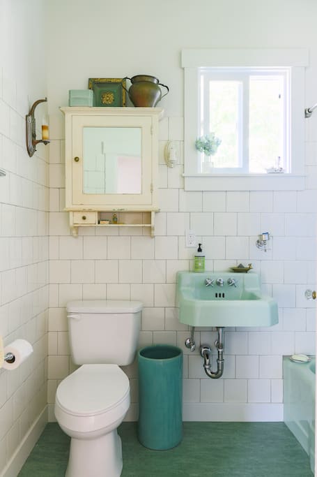 Shared bath with deep soaking tub and tankless water heater.
