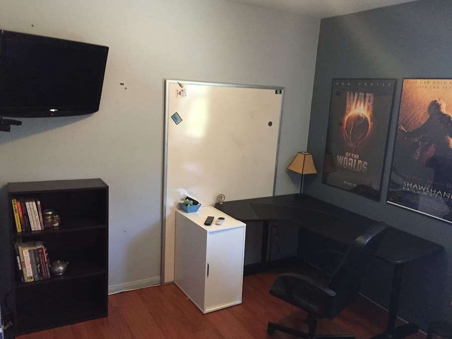 There's a TV on moveable mount. Desk for working with comfy office chair. Whiteboard for to do lists, or doodling. Posters of Tim Robbins best film, and Spielberg's, uh, not best.