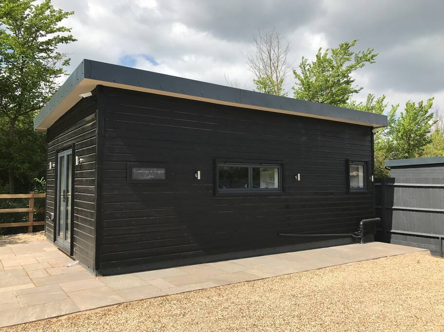 Detached cabin with security lighting.