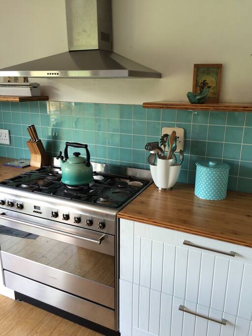 Big, beautiful and bright kitchen, with middle island has a stacking door which opens out to the back yard and has an adjoining scullery.