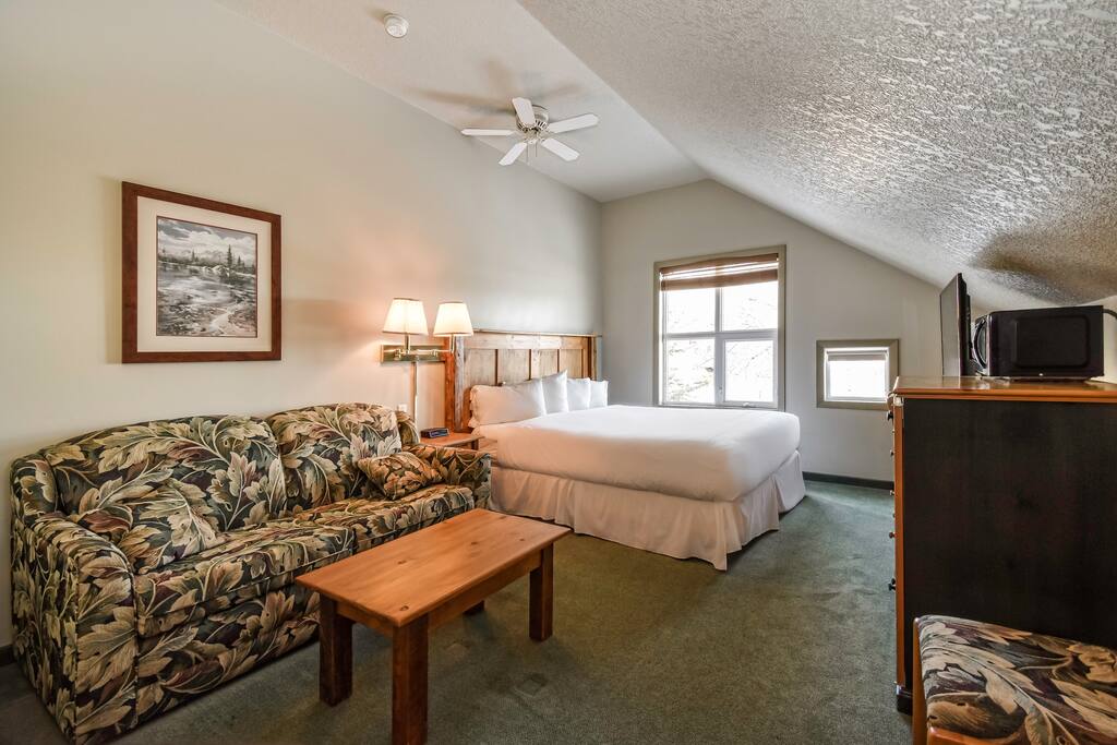 Queen bed with comfy mattress and a sofa