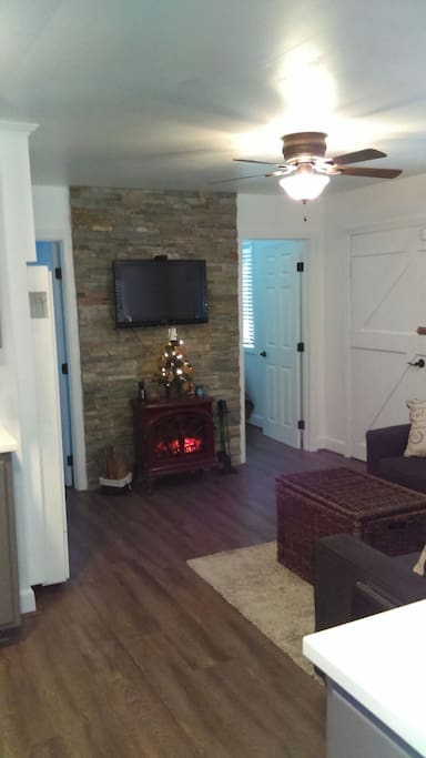 The beauty of an electric fireplace accompanied by a flat-screen TV with Netflix, Hulu, and a DVD for your enjoyment