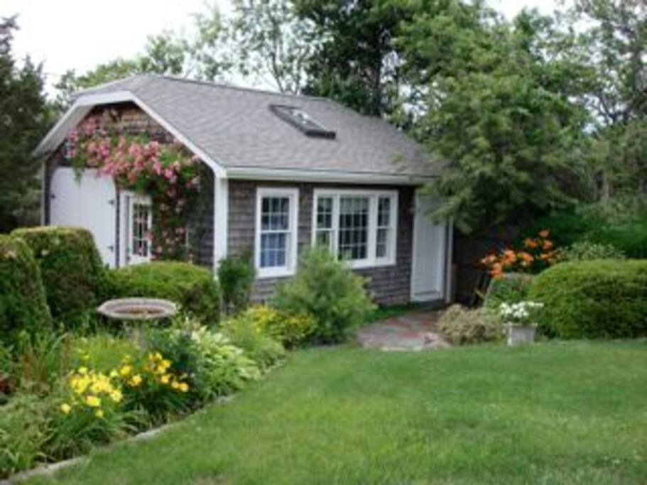 Cottage located on grounds of lovely home with manicured gardens.