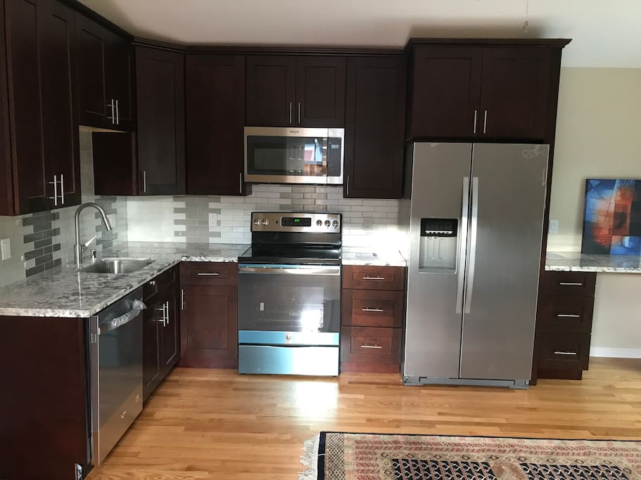 Kitchen with full stove, fridge, dishwasher