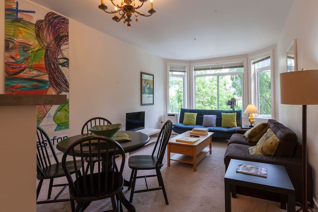 Living room/ dining room with couch and full futon bed