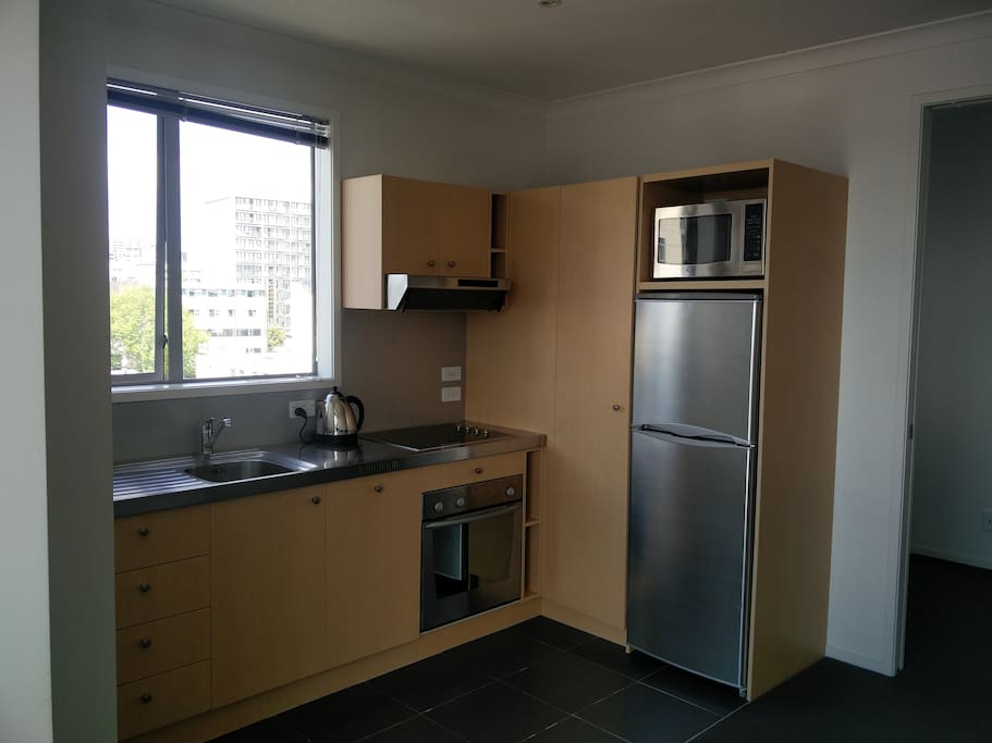 Kitchen with fridge, freezer, oven, microwave, and dishwasher