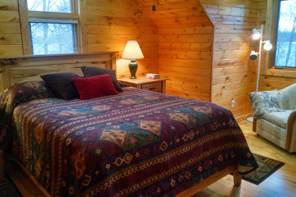 Your private oasis! Bedroom (1) with lake view and cozy reading corner.