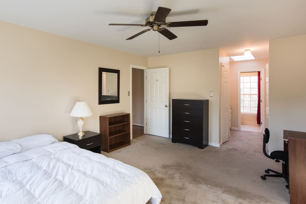 The window on the right is in the shower and opens to a wooded park.