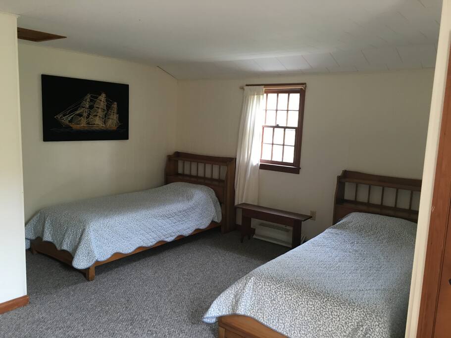 Spacious upstairs bedroom with twin beds