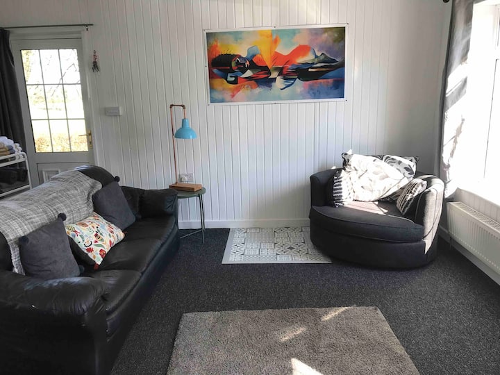 Fabulous bright  living room, perfect for relaxing in, smart tv with in built DVD player, lots of great dvd movies in press under tv. USB charging points for your use in living room