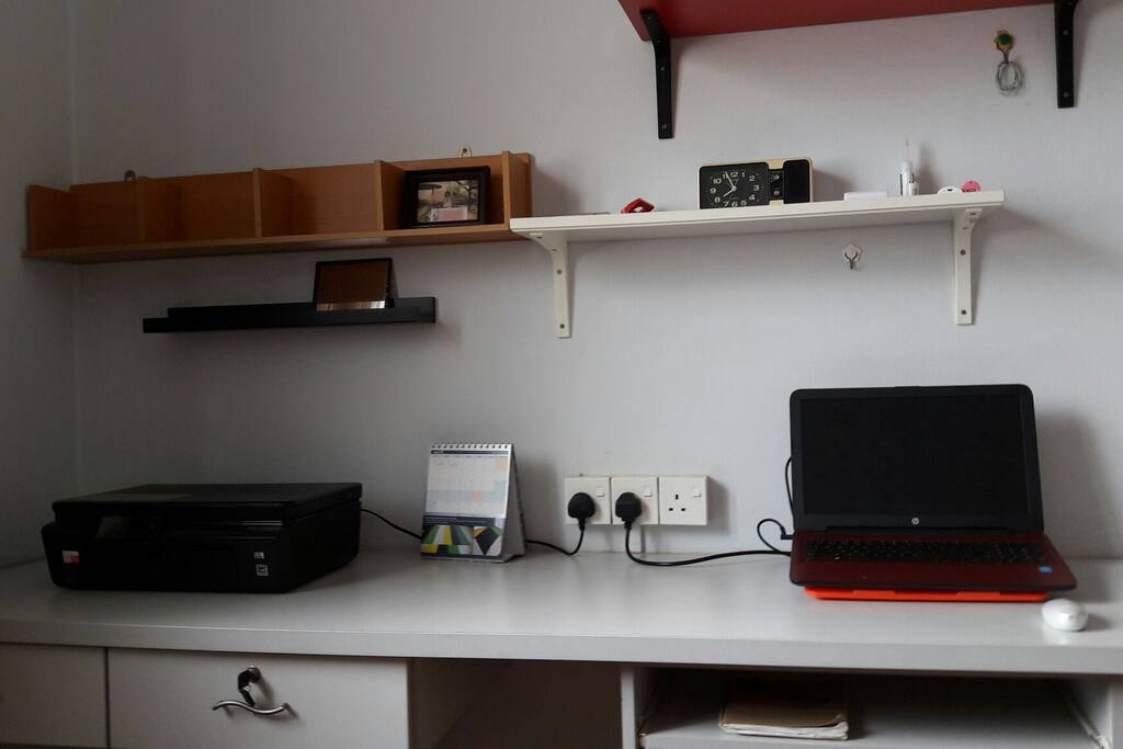 Long multipurpose table with wall shelves