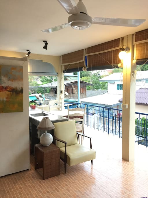 On the left, the balcony is open to the fisherman village by the sea where walking distance is 50m away. Guests also have a mountain view of Khaotao (refers to "Turtle Hill") where one can take a short scenic hiking to reach nearby famous Sai Noi Beach. The dining table is good for two but we accommodate two extra portable chairs kept in the closet.