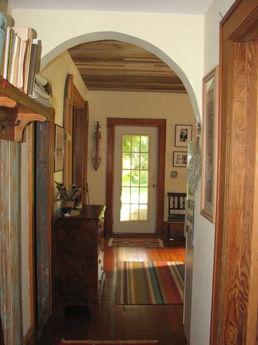 Hallway from North porch entry looking south into kitchen / dining room