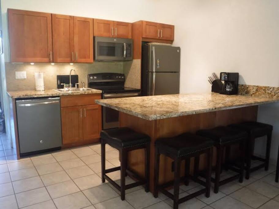 Fully stocked kitchen featuring new appliances, cabinets and granite counters
