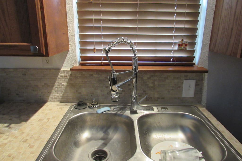 Dual sink, easy sprayer, disposal, cabinets and drawer space. Dishes for 2 and Coffee maker