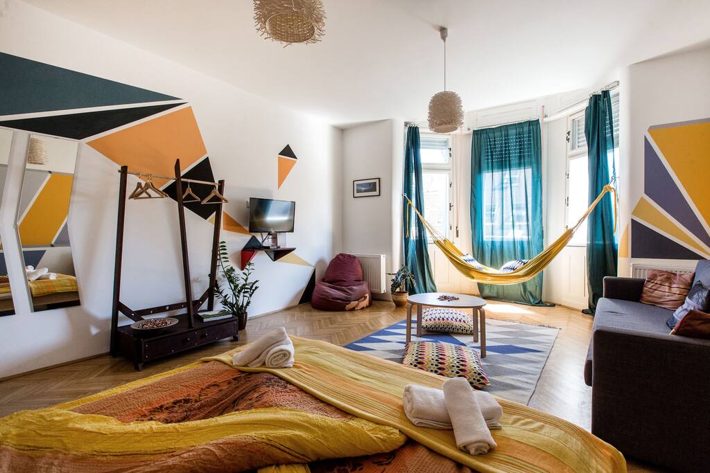 living room with king size bed and sofa