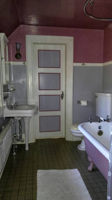 Bathroom connected to the room includes a claw-footed tub/shower.