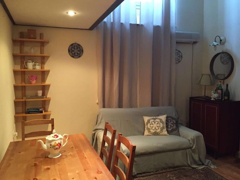 The living area with sofa bed and dining table