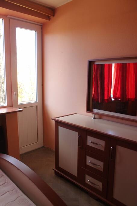A bedroom with a comfortable queen-zise bed, opens to a balcony