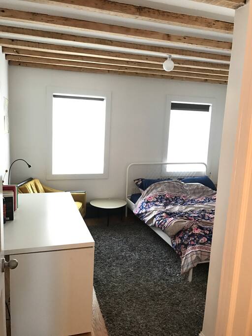 Bedroom 1 - queen size memory foam mattress, large closet, easy chair, and some cool exposed beams