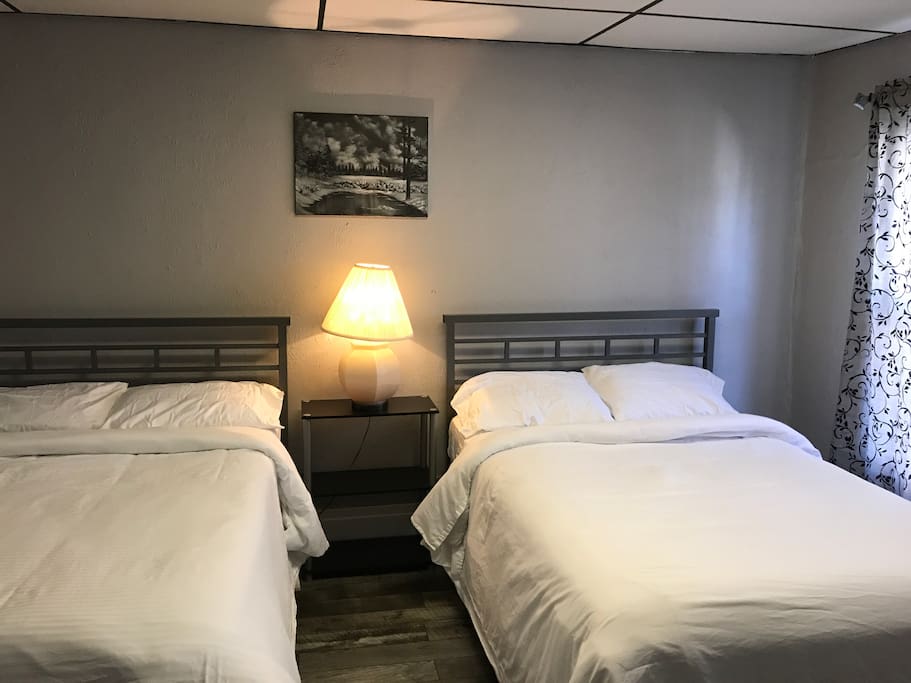 Room 7 with two full size bed and a private bathroom in the middle off from room 9. Room 7 has just been remodeled hard wood laminated floors. Carpet was removed