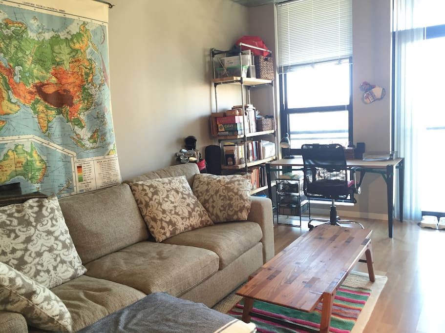 Comfy couch, desk space, and board games on the shelf.