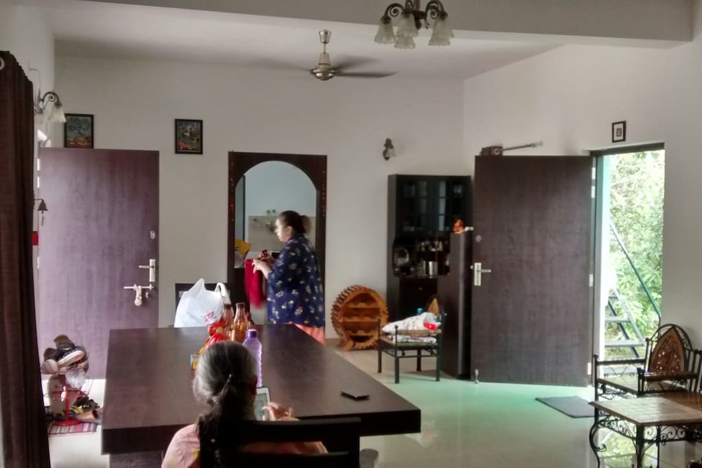 The huge living room with a 10 seater dining table and enough sitting space !