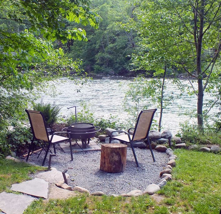 Fire pit area next to river bank with high spring river level