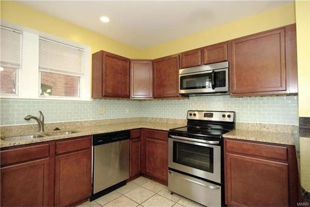 Kitchen fully stocked with essential utensils and appliances