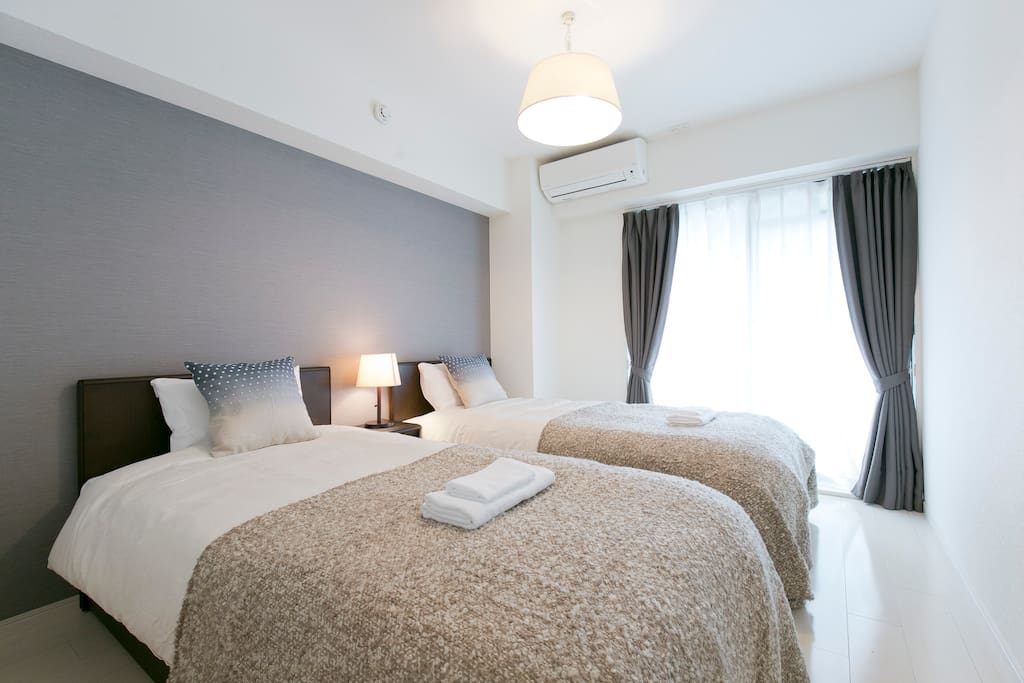 The Bedroom with 2 single beds. Clean and minimal is modern Tokyo style
