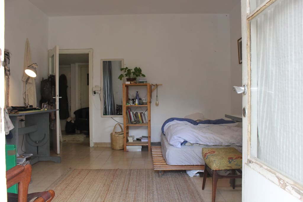 cosy airy and lit bedroom. exit to a balcony