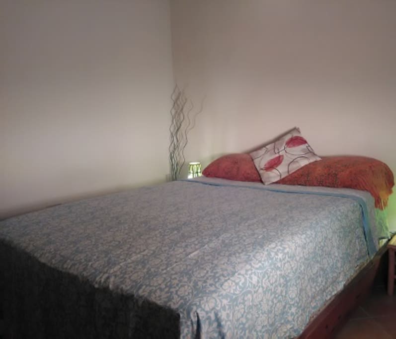 Double bed in wooden paneled-room