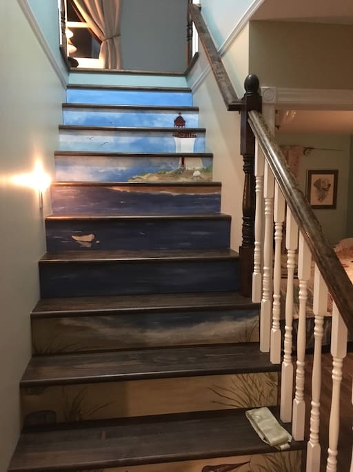 The central staircase features a painting of "Cap Lumiere" done by one of our local artists.