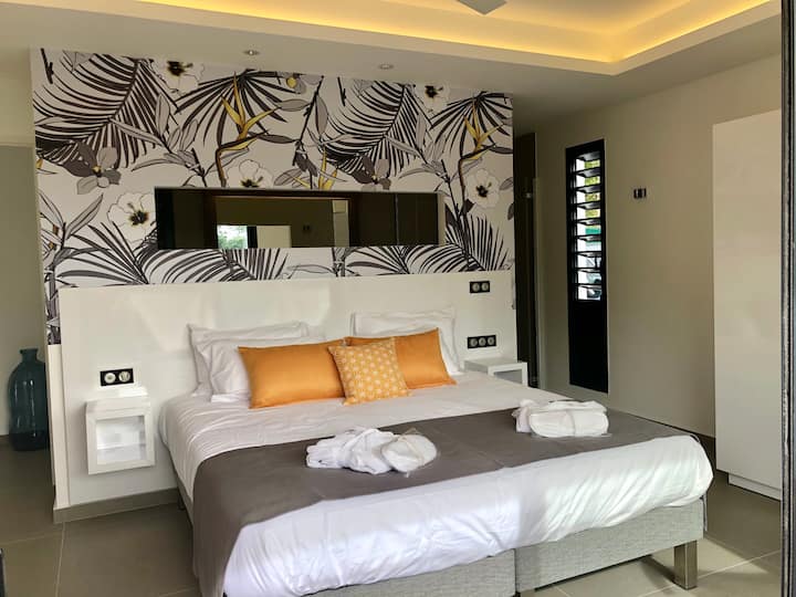 Tropic & Chic Villa Chuty: cama amplia y cómoda y baño semiabierto.