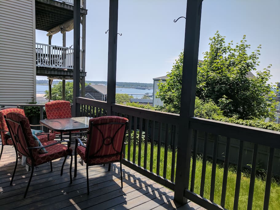 Huge private deck has water views and leads to the grassy backyard. Perfect for lawn games or move the chairs out into the sun!