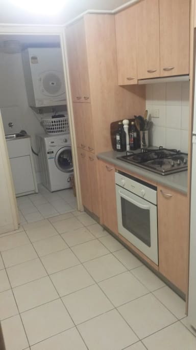 Kitchen with walk through to laundry- fully equipped with gas cooking, fridge/freezer & dishwasher