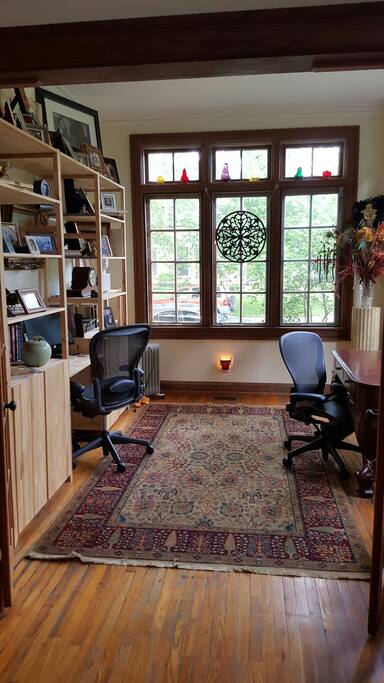 Office with two desks, wireless internet and printer in cabinet.