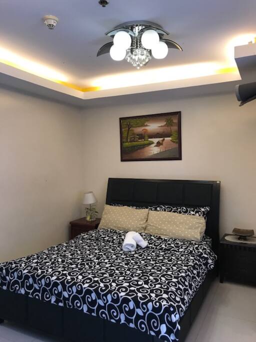 Beautiful lighting over a comfortable bed