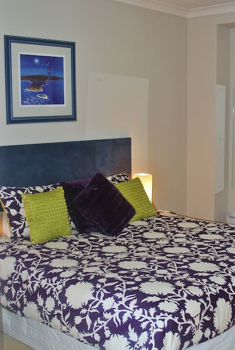 The bedroom is spacious with king sized bed and quality linen
