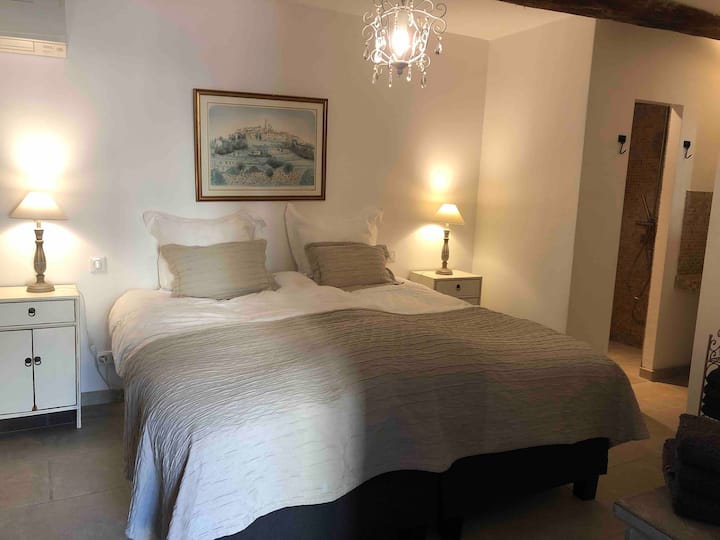 The bedroom downstairs on the ground floor. Sits at a hallway behind the living room. Has a king size bed (180x200 cm) and shower and toilet