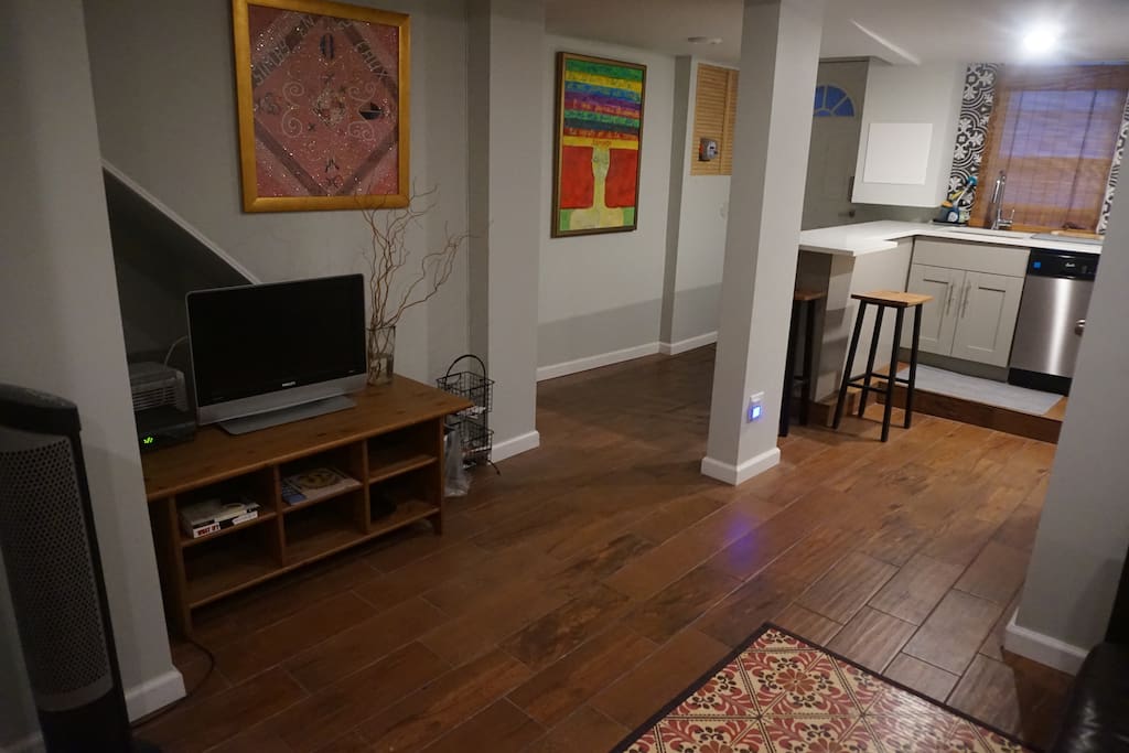 View from living room to kitchen area with stool area to sit and storage for groceries if needed.