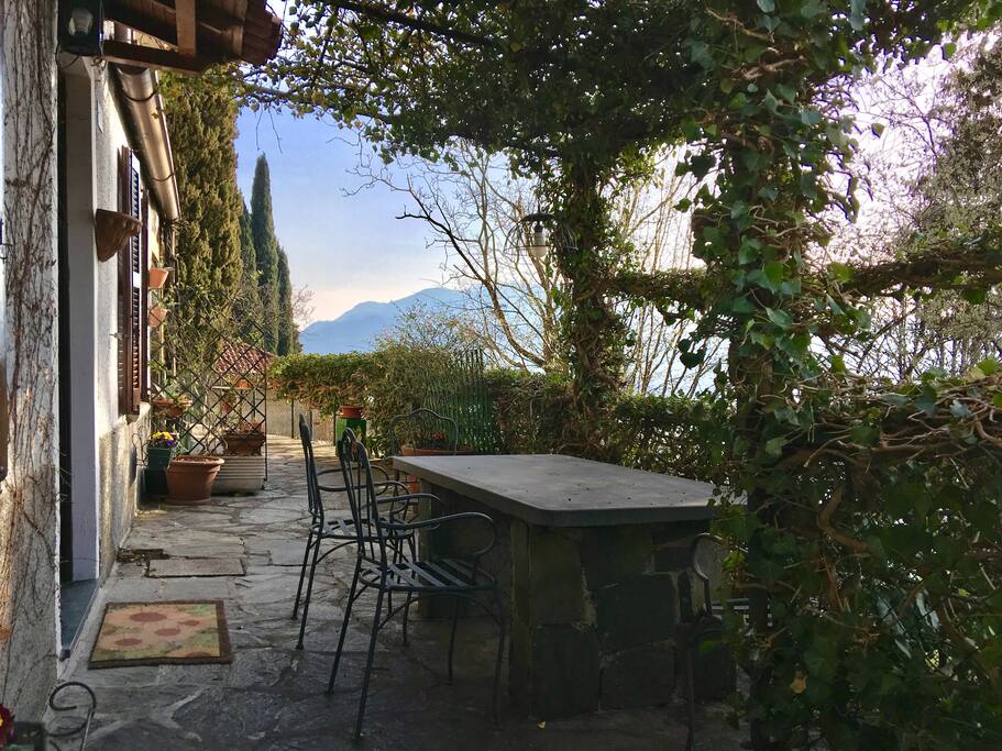 Beautiful vine-covered entrance and outdoor seating area.